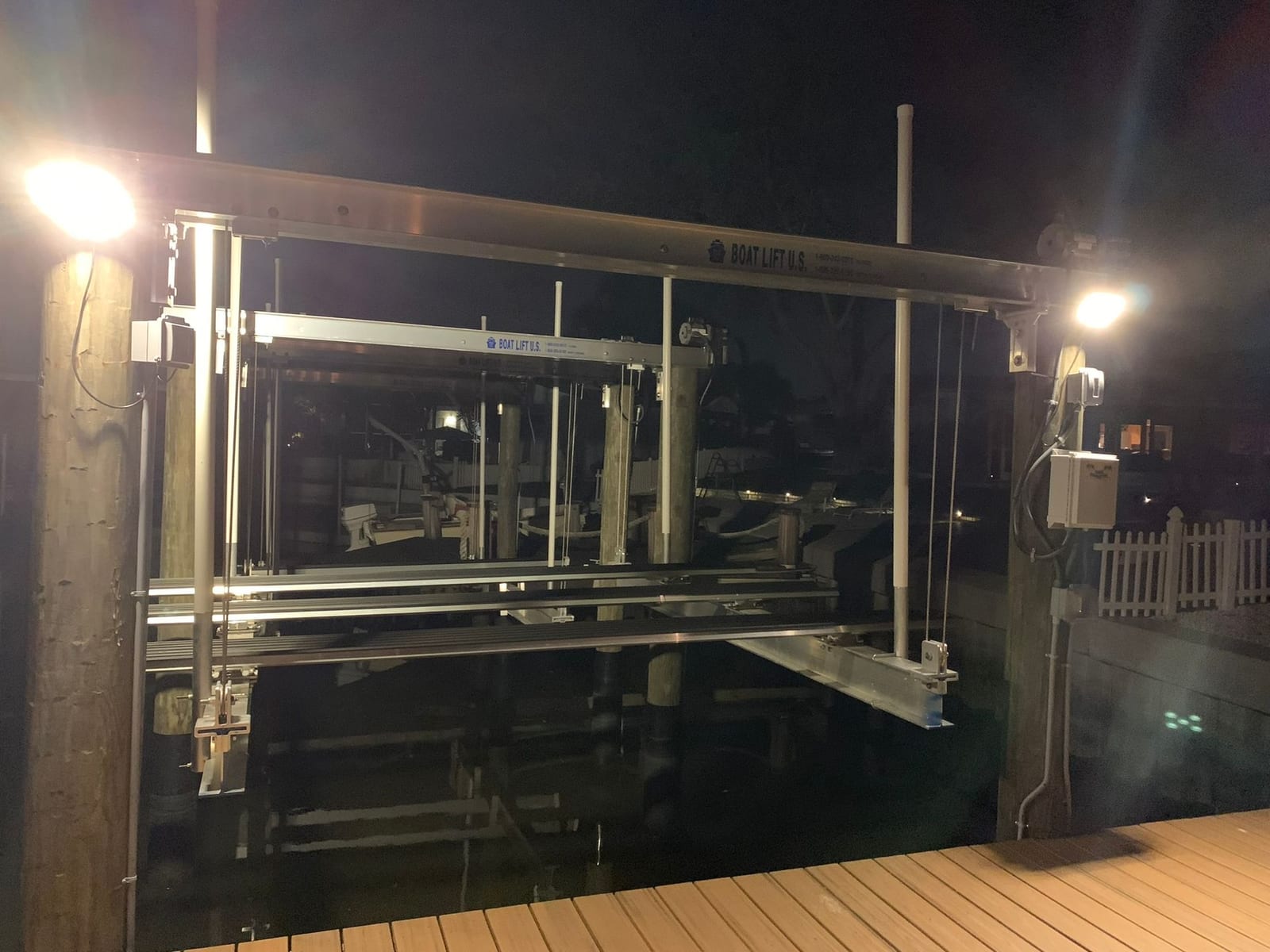 Boat lift motors, weatherproof controls and dock flood lights wired on a canal-front dock by Lightning Bay Electric near Apollo Beach, FL
