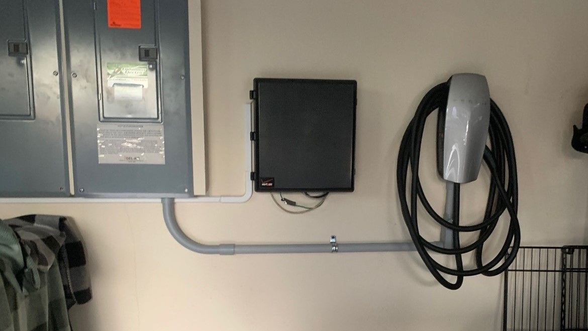 ChargePoint Home Flex EV charger mounted beside the electrical panel in a garage, installed by Lightning Bay Electric in Brandon, FL
