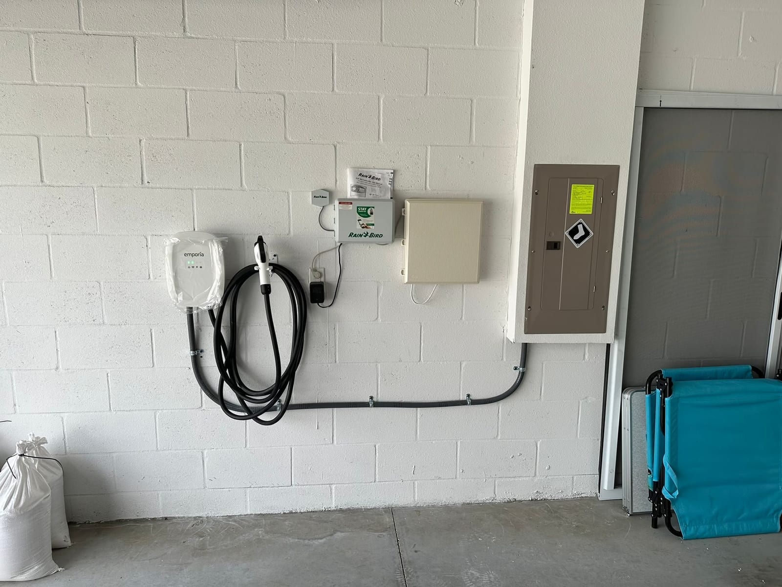 Emporia Level 2 EV charger wired in conduit to a new garage subpanel by Lightning Bay Electric in a Tampa, FL home