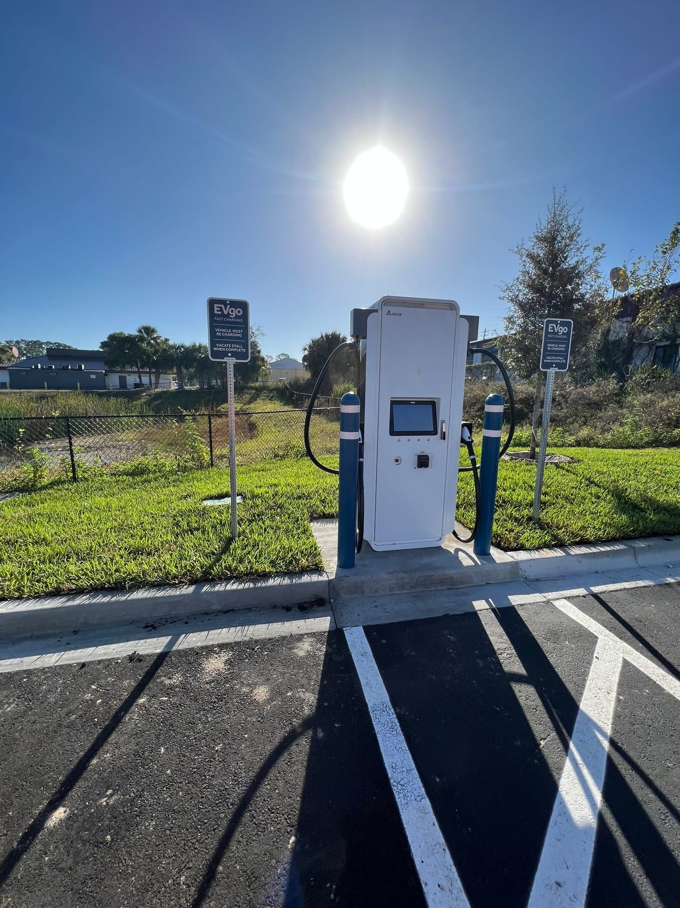 EVgo DC fast-charging station with bollards and signage installed in a commercial parking lot by Lightning Bay Electric in the Tampa Bay area
