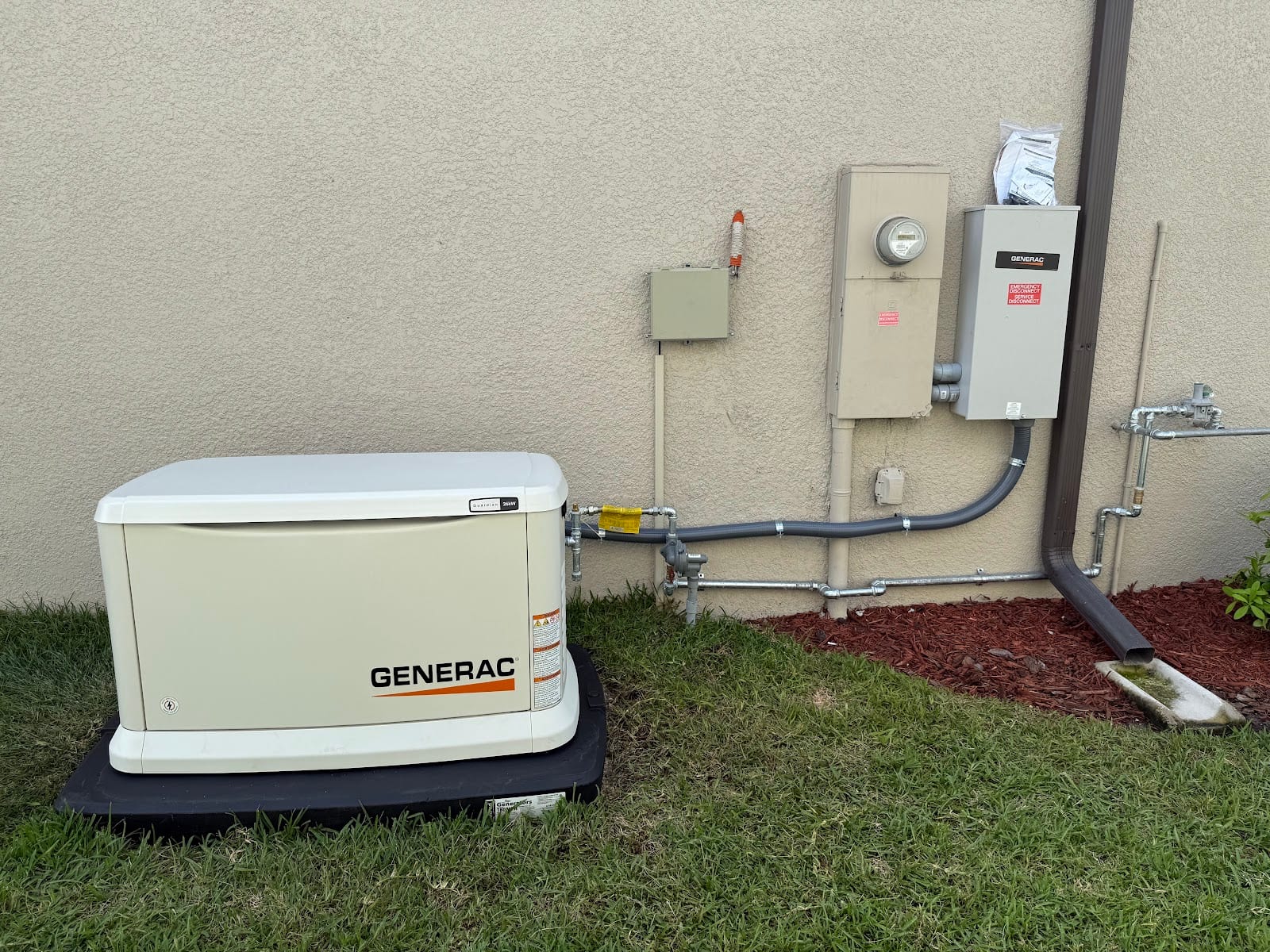 Generac Guardian 26kW whole-home generator with Generac automatic transfer switch and gas piping installed by Lightning Bay Electric at a Tampa Bay home