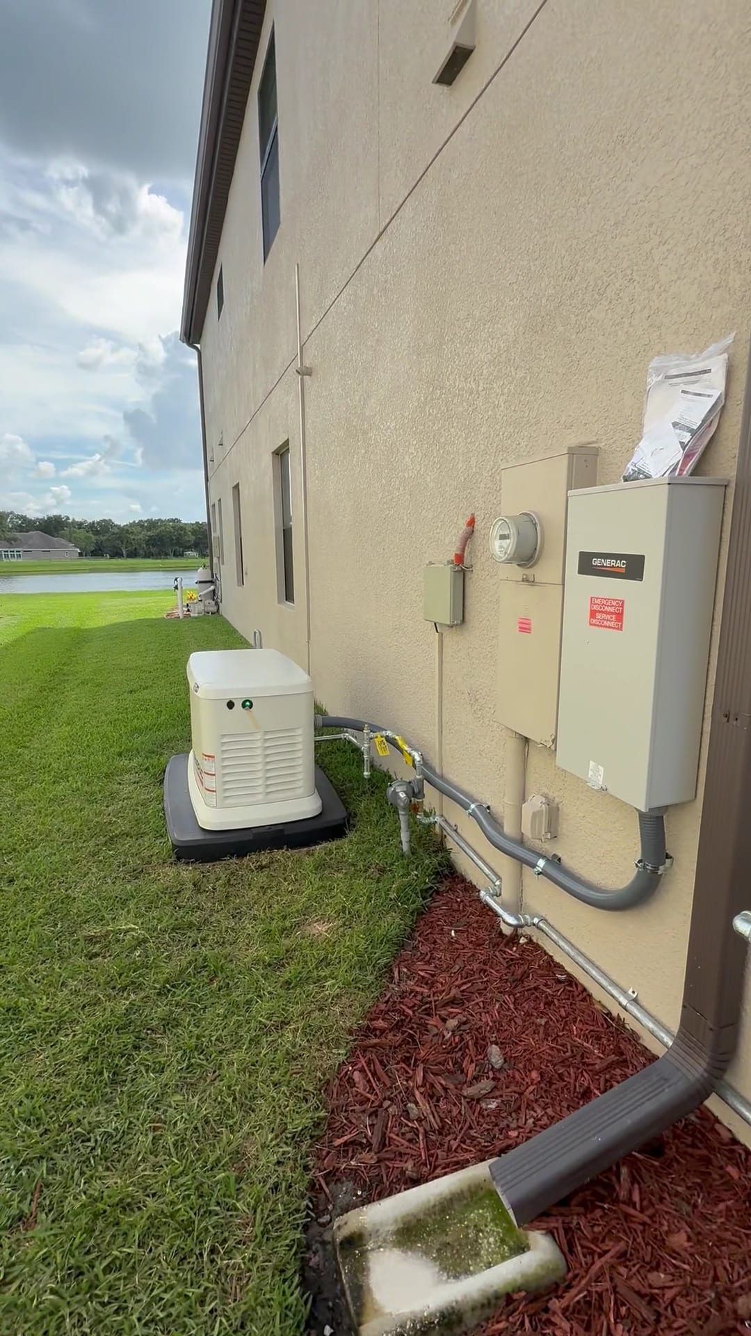 Generac standby generator and automatic transfer switch with emergency disconnect installed at a lakefront Tampa Bay home by Lightning Bay Electric