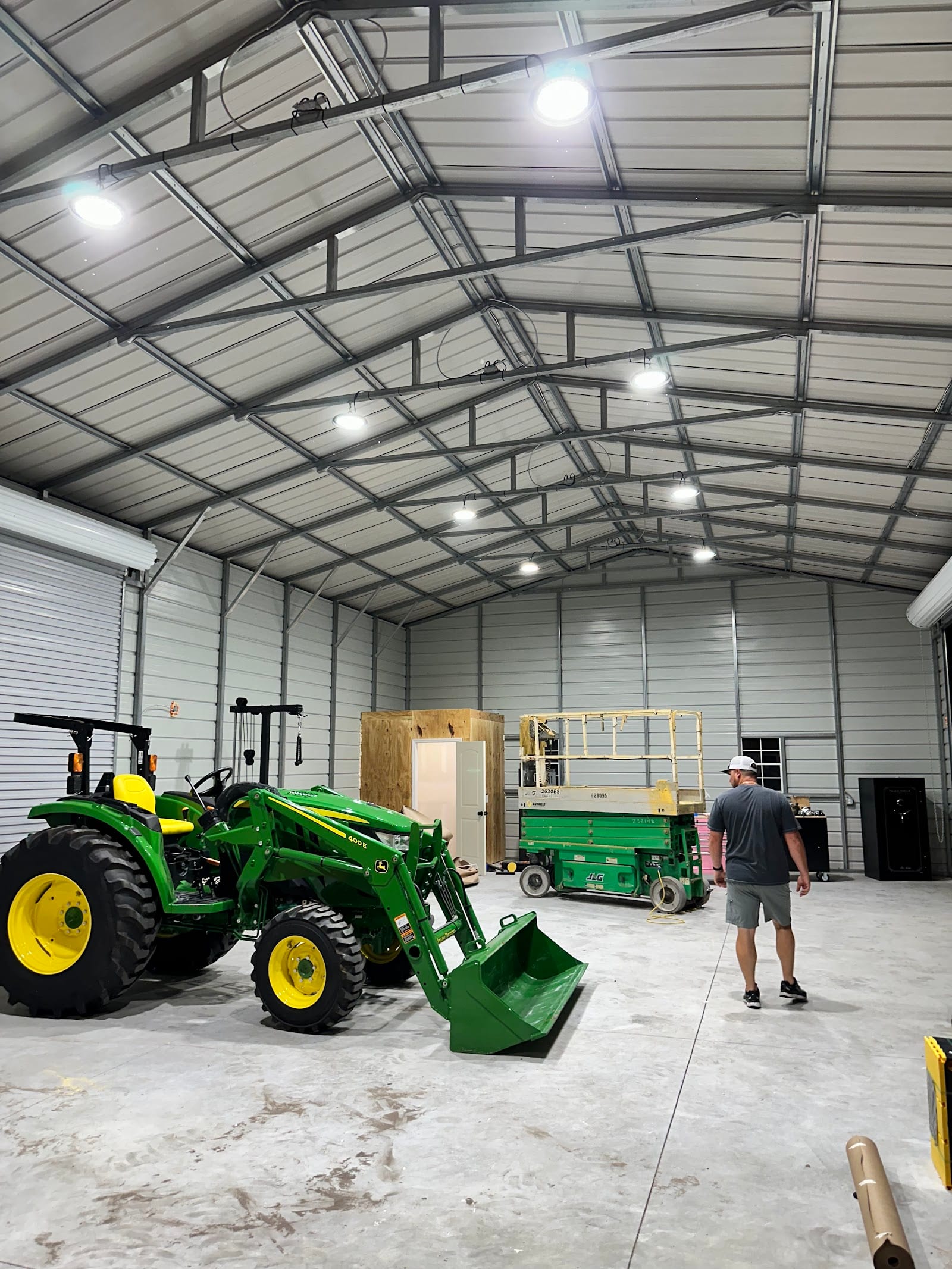 New high-bay LED lighting installed across the trusses of a steel workshop building by Lightning Bay Electric in the Tampa Bay area