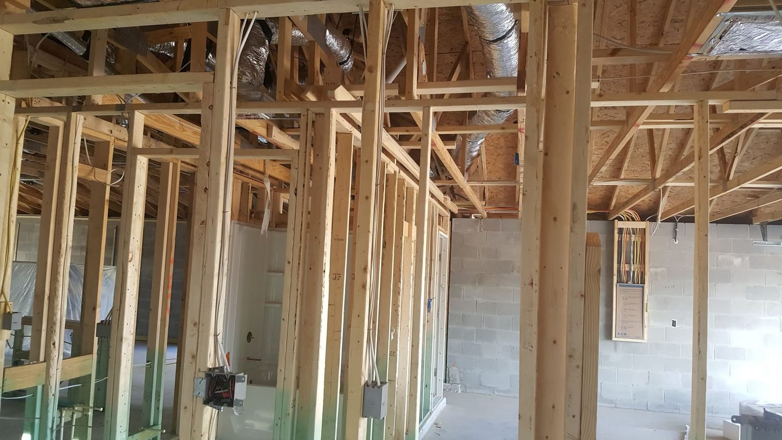 Electrical rough-in wiring, boxes and panel stub-up in a framed new-construction block home by Lightning Bay Electric in Riverview, FL