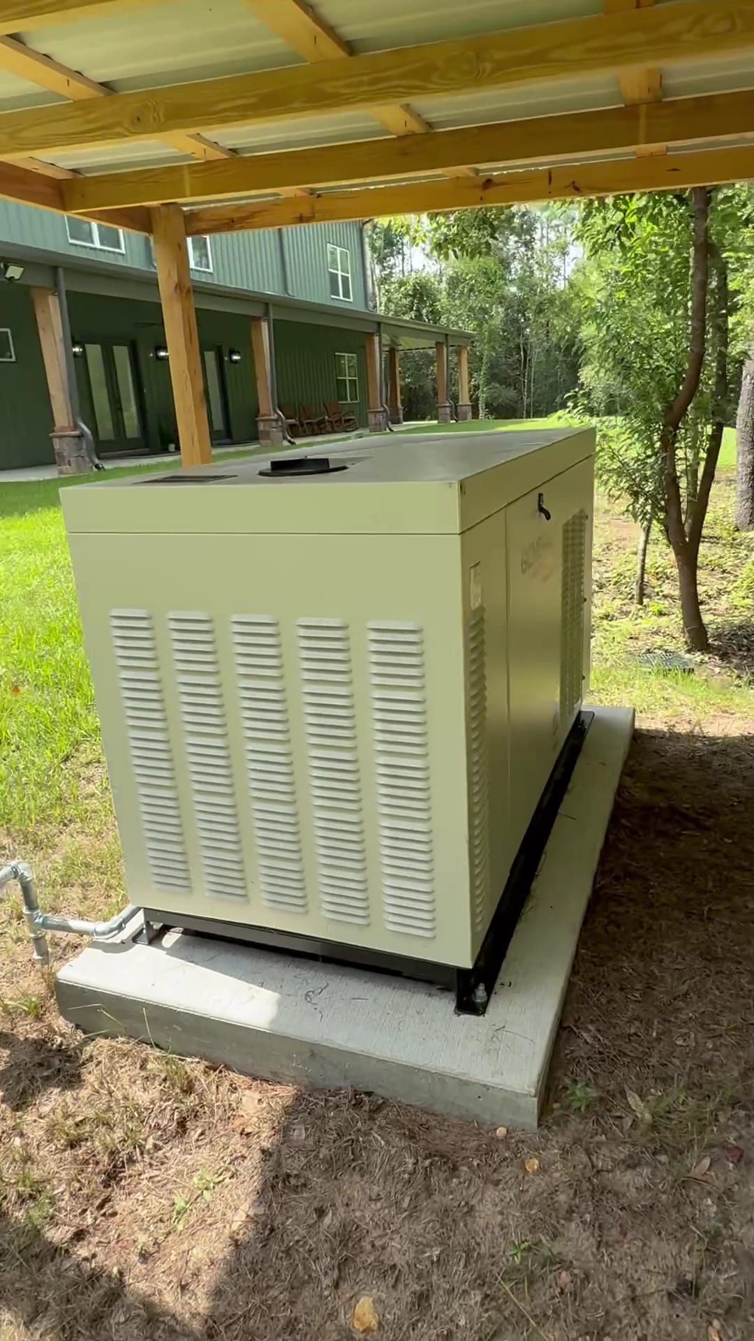 Whole-home standby generator installed on a concrete pad under a pole barn at a Tampa Bay area barndominium by Lightning Bay Electric