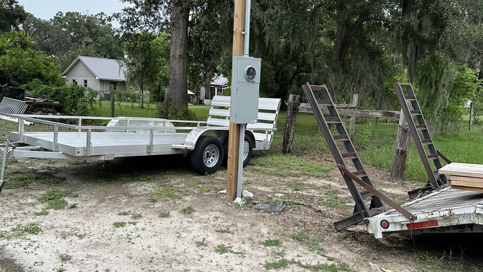 Temporary construction power pole with meter set by Lightning Bay Electric on a rural new-build lot in Lithia, FL