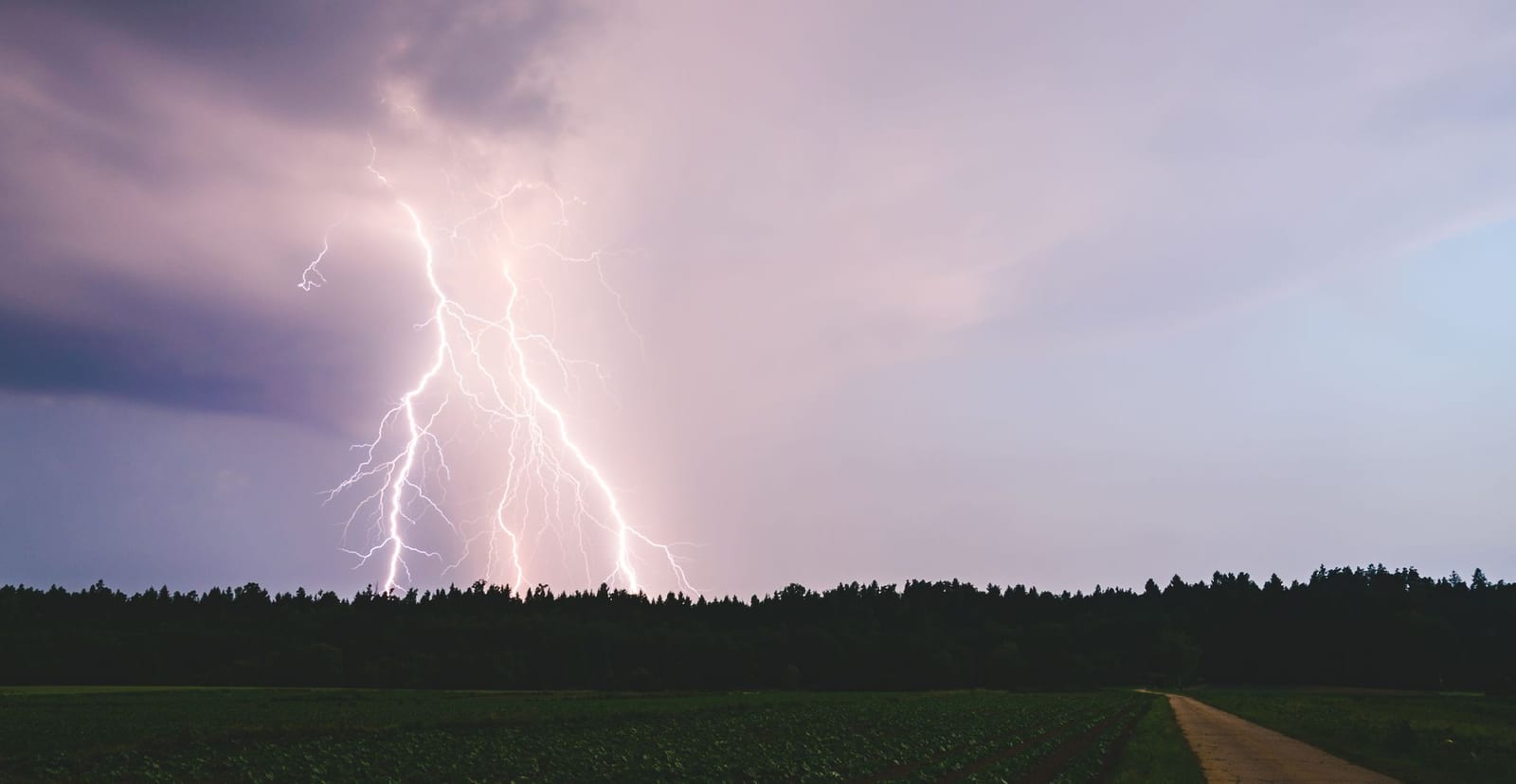 Dramatic lightning bolt at night over Florida, illustrating the power surges a whole-home surge protector from Lightning Bay Electric stops at the panel