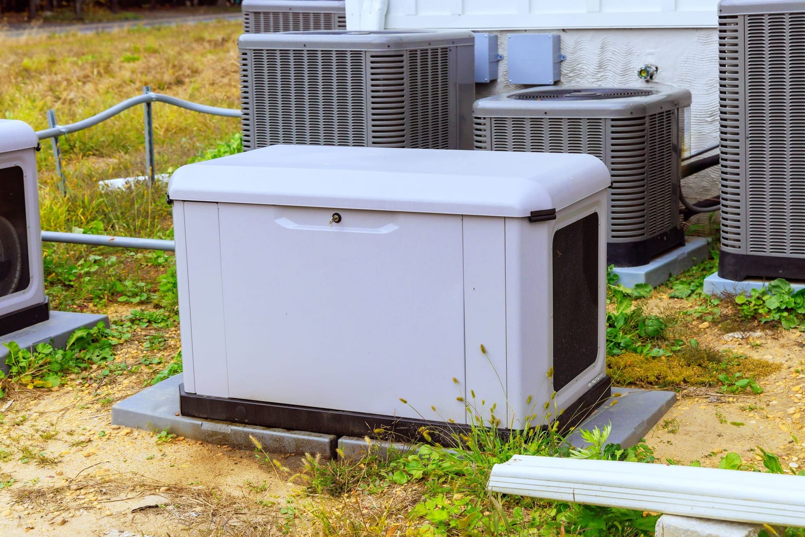 Whole-home standby generator on a concrete pad beside a house, the type of natural gas or propane backup system Lightning Bay Electric installs across Tampa Bay